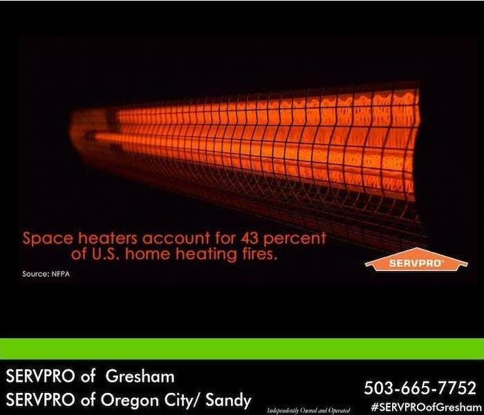 Red space heater on a black background